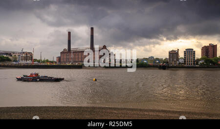 London, England, UK - May 24, 2013: Storm clouds pass over Chelsea's Lots Road Power Station on the banks of the River Thames in west London. Stock Photo