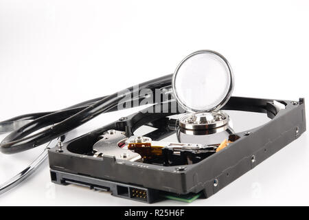 RECOVERY AND REPAIR TECHNOLOGY CONCEPT: Hard Disk Drive (HDD) with stethoscope isolated on white. Stock Photo