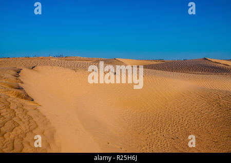Tunisian desert landscape with blue sky. Dunes background Stock Photo