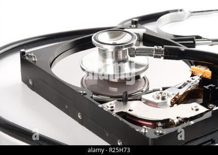 RECOVERY AND REPAIR TECHNOLOGY CONCEPT: Hard Disk Drive (HDD) with stethoscope isolated on white. Stock Photo