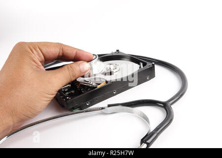 RECOVERY AND REPAIR TECHNOLOGY CONCEPT: Hard Disk Drive (HDD) with stethoscope isolated on white. Stock Photo