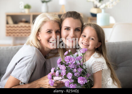 Portrait of happy three generations women family celebrating bir Stock Photo