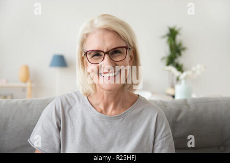 Smiling middle aged mature grey haired woman looking at camera Stock Photo