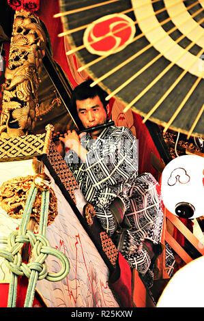 KYOTO, JAPAN - JULY 15, 2011: An unidentified male performer on the portable shrine during the Gion Festival in Kyoto, Japan Stock Photo