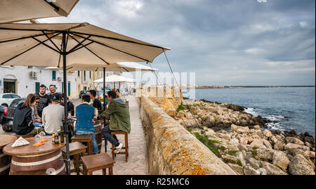 Sidewalk cafe at sea wall, Ionian Sea waterfront, at Riviera Armando Diaz, boulevard in Gallipoli, Apulia, Italy Stock Photo