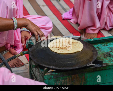 Cooking Tandoori naan or Roti at local restaurant in Jodhpur, India. Stock Photo