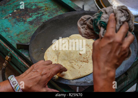 Cooking Tandoori naan or Roti at local restaurant in Jodhpur, India. Stock Photo