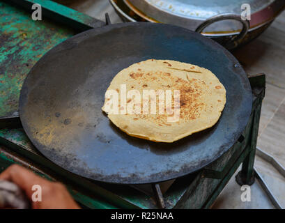 Cooking Tandoori naan or Roti at local restaurant in Jodhpur, India. Stock Photo