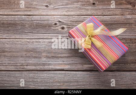 Gift on a wooden surface. There is a place for your text. Stock Photo