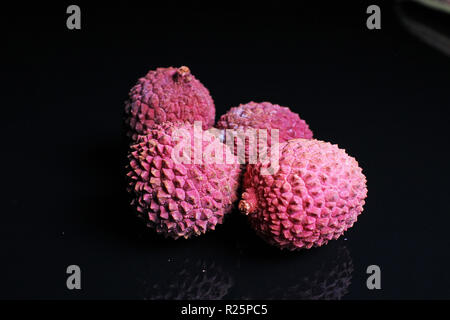 Litchi chinensis lychee sweet fruit on black background Stock Photo