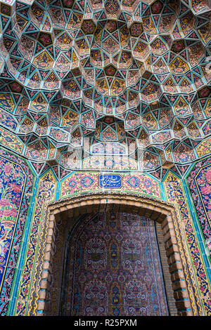 An entrance to the Pink Mosque with traditional Iranian decoration of the façade ever the doors in Shiraz, Iran on September 14,2018. Stock Photo