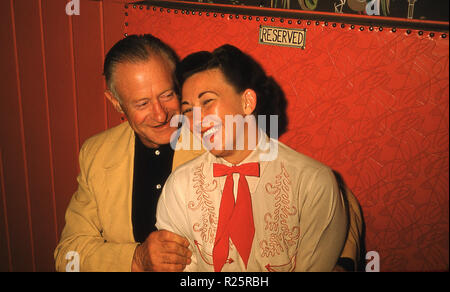 1950s, historical, a happy man and woman relax sitting closely together in a reserved seat at a country & western club or bar in mid-west America. Stock Photo