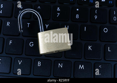 Unlocked padlock on computer keyboard Stock Photo