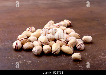 Salt pistachios on a stone table. Close-up Stock Photo