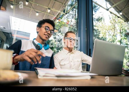 Nice young students sitting at the table Stock Photo