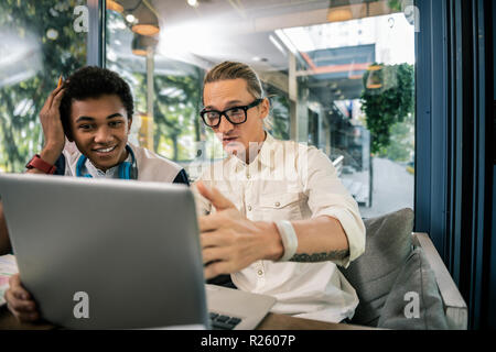 Positive nice man helping his best friend Stock Photo