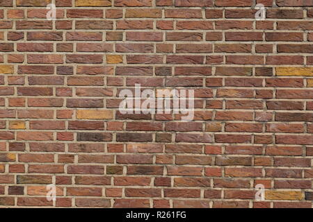 Old red brick wall showing signs of age and decay mortar. Stock Photo