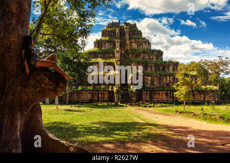 Brave traveler woman explores Pyramid death Prasat Thom Koh Ker lost in tropical rain forest jungle Cambodia Stock Photo