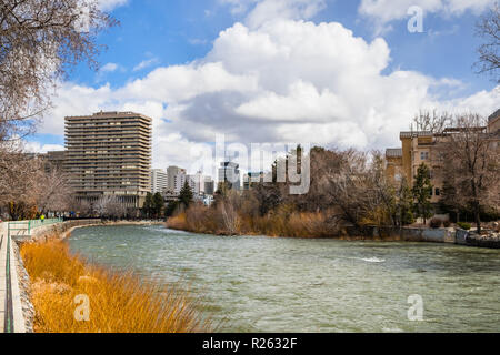 Reno, Nevada skyline as seen from the shoreline of Truckee river flowing through downtown; Stock Photo