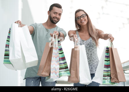 happy husband and wife showing their shopping bags Stock Photo