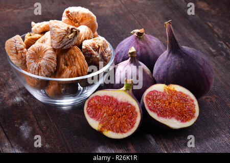 Composition with fresh and dried figs on wooden table. Stock Photo