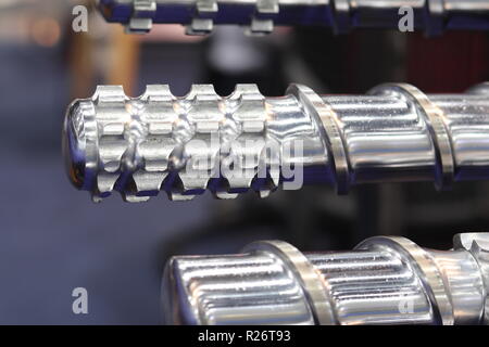 Screw press parts for plastic injection machine ; selective focus Stock Photo