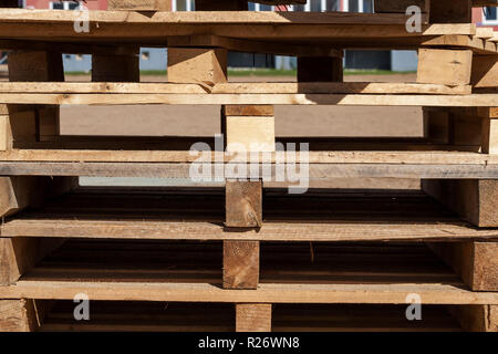 old empty wooden pallets from tiles, lie on construction site Stock Photo