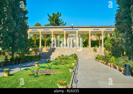 The scenic Mussala Gardens with funeral complex of famous Persian poet Hafez, the Mausoleum, located in alcove, is seen behind the colonnade, Shiraz,  Stock Photo
