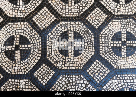 Mosaic on the floor in the shape of a cross. Old mosaic on the floor as a background. Stock Photo