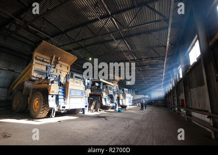 Yellow quarry dump trucks in service zone Stock Photo