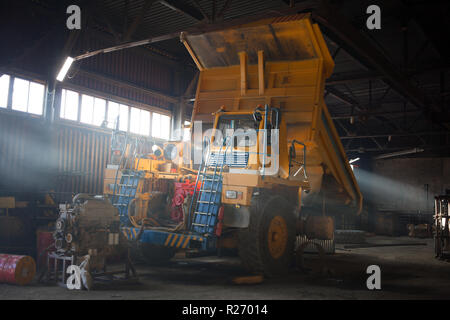 Yellow quarry dump truck in service zone Stock Photo