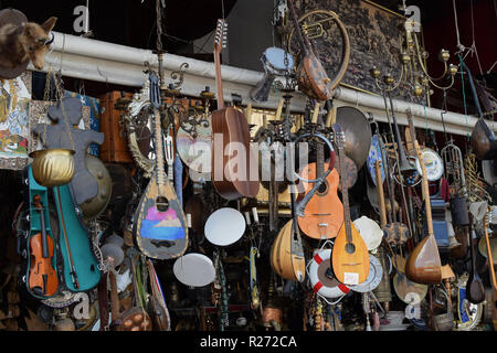 ATHENS, GREECE - AUGUST 29, 2018: Vintage musical instruments and antique objects at traditional flea market store. Stock Photo