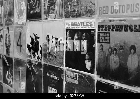 ATHENS, GREECE - AUGUST 29, 2018: Wall with vintage vinyl records pop and rock music album sleeves background. Selective focus black and white. Stock Photo