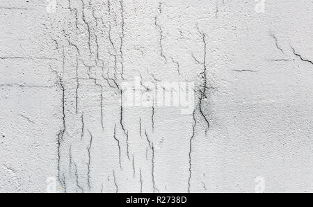 Texture of white dirty cracked wall. Small straight cracks. Direct fracture on painted surface. Cells fissure Stock Photo