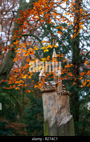 A fairytale castle carved into a tree trunk. Autumn at the Rococo Garden, Gloucestershire, UK. Situated in the Cotswolds. Stock Photo