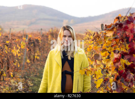 pregnant woman walking outdoor in autumn nature Stock Photo