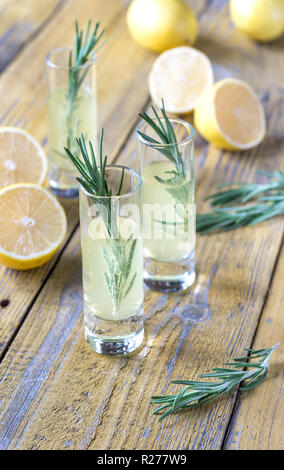 Glasses of limoncello on the wooden background