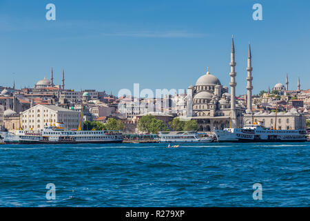 Istanbul, Turkey, May 28, 2013: View of the New Mosque (Yeni Camii) across the Golden Horn, with ferry boats in front. Stock Photo