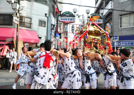 Osaka, Japan - July 25, 2012: Golden portable shrine carried and worshipped by participants of the Tenjin Matsuri Festival Stock Photo