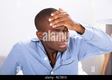 Close-up Of A Young African Man Suffering From Headache Stock Photo