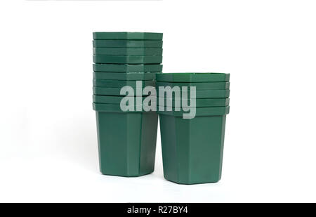 Empty plastic green flower pots isolated on white background. Stock Photo