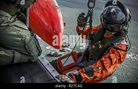 Royal Navy Search & Rescue operating from RNAS Culdrose on a training mission over the coast of Cornwall. Stock Photo