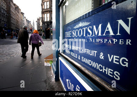 A sign showing The Scotsman newspaper masthead in a newsagent's window on the Royal Mile in Edinburgh. Stock Photo