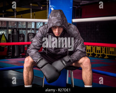 Aggressive man in boxing gloves on ring Stock Photo