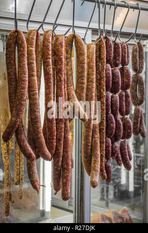 Various home made sausages hanging in the butcher shop Stock Photo