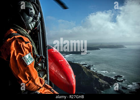 Royal Navy Search & Rescue operating from RNAS Culdrose on a training mission over the coast of Cornwall. Stock Photo