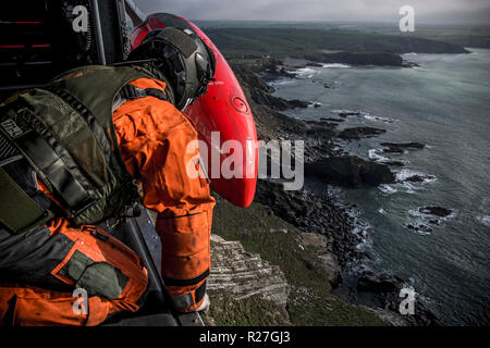 Royal Navy Search & Rescue operating from RNAS Culdrose on a training mission over the coast of Cornwall. Stock Photo