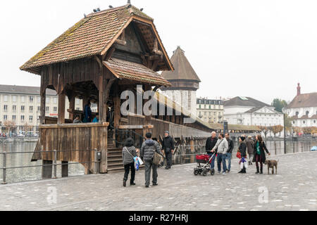 Lucerne, LU / Switzerland - November 9, 2018: tourists visit the famous Swiss city of Lucerne and take pictures of themselves with the Chapel Bridge Stock Photo