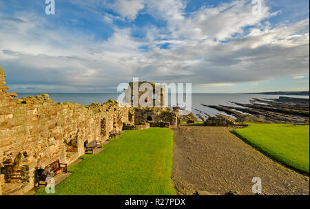 ST ANDREWS FIFE SCOTLAND THE CASTLE RUINS SEATS ALONGSIDE THE WALLS AND SUNSHINE
