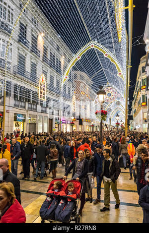Crowds of people walking on Calle Marques de Larios street, decorated with Christmas decorations, Malaga, Spain Stock Photo